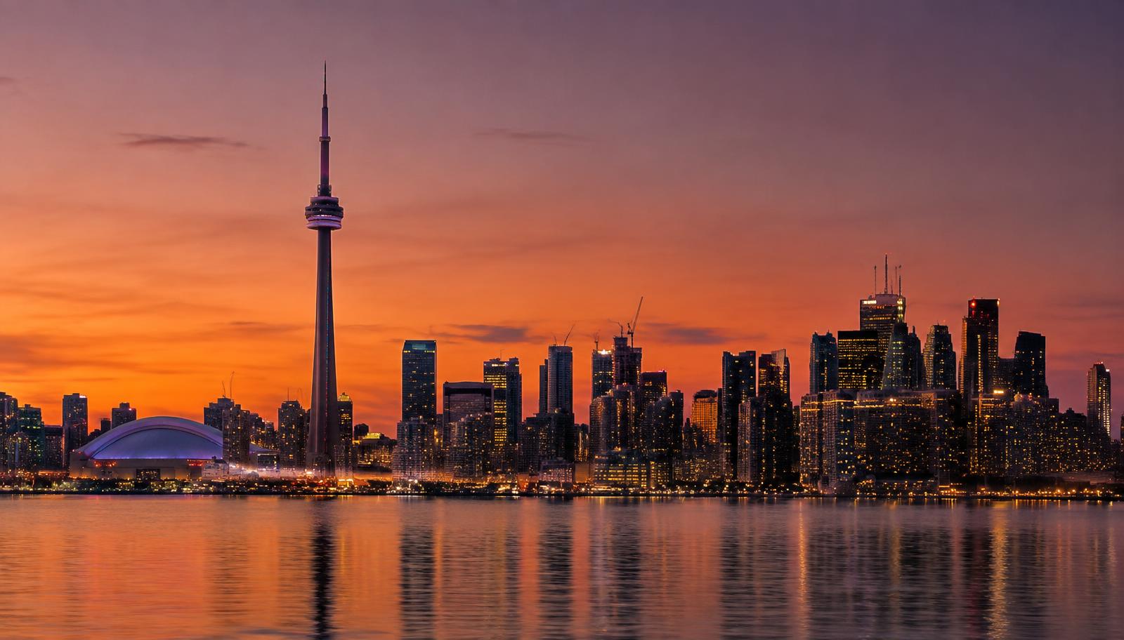 Toronto skyline and CN Tower at dusk over Lake Ontario